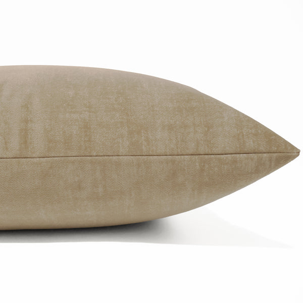 A close-up of a textured beige throw pillow with a subtle linen-like fabric, shown against a clean white background.