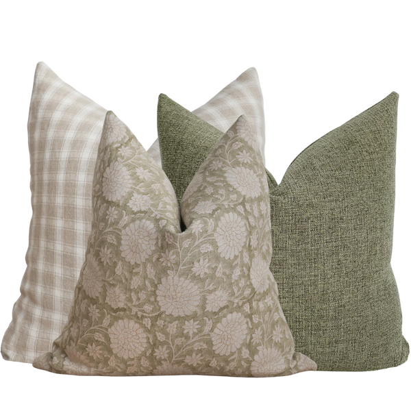 Set of four decorative pillows with different patterns on a white background