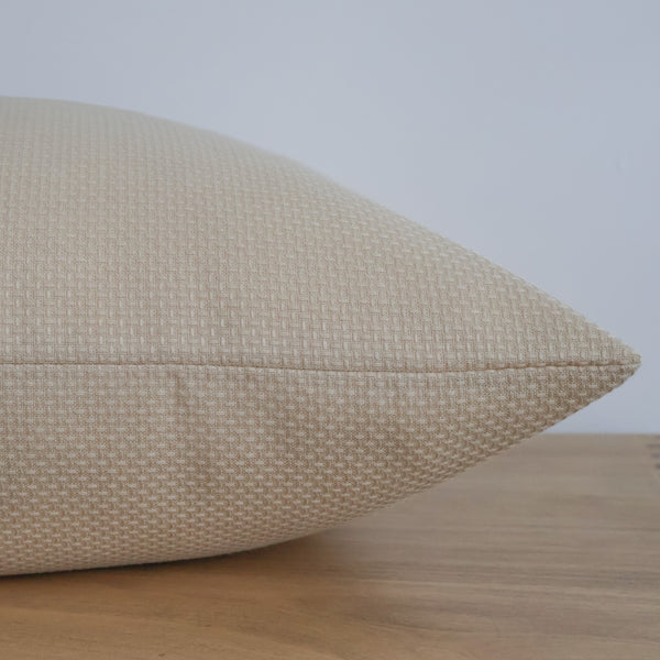Close-up of Sunlit Weave's softly woven texture in cream-gold Sunbrella® performance fabric.