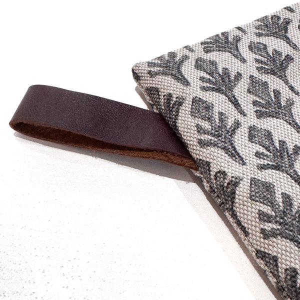 Close-up of the botanical leaf print and leather hook detail on the Charcoal Leaf Christmas Stocking.