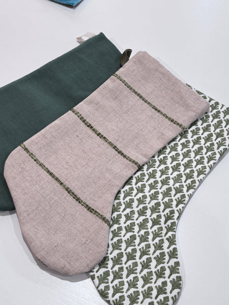 Detail view of the green and flax linen pattern on the Boho Stocking Set of Three.
