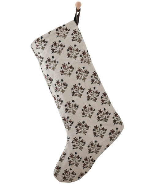Auburn Floral Block Print Stocking, large natural linen Christmas stocking with hand-printed rust, olive and black floral motifs, hanging from a wooden peg on a white paneled wall