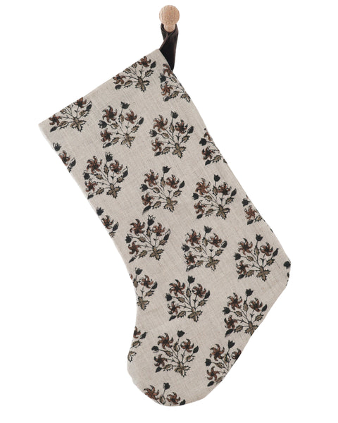 Auburn Floral Block Print Stocking, large natural linen Christmas stocking with hand-printed rust, olive and black floral motifs, hanging from a wooden peg on a white paneled wall