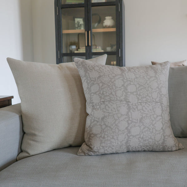 Gray sofa with patterned cushions in a living room setting