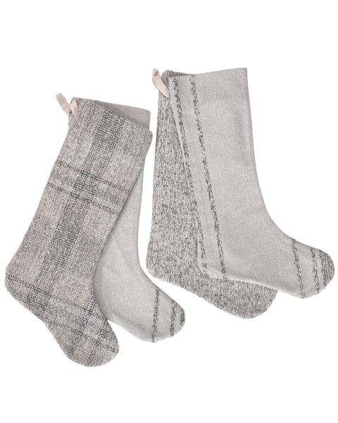 Three gray knit Christmas stockings with hanging loops, displayed against a plain white background. Two stockings feature a subtle plaid pattern, and one is solid light gray with vertical stripe details.