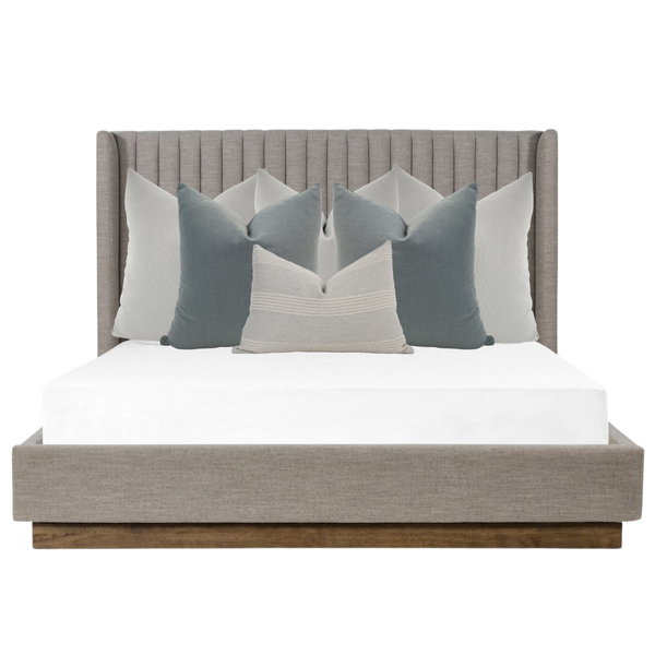 Hackner Home Moonlit Fog bed pillow combo styled on a modern gray channel-tufted bed with layered blue-gray and ivory pillows for a calming, elegant bedroom look.