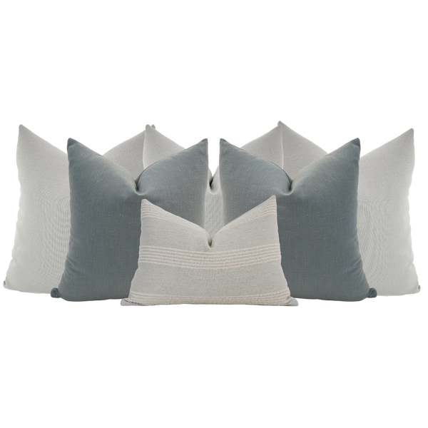 Hackner Home Moonlit Fog pillow set featuring layered blue-gray and ivory decorative pillows in a modern, serene neutral arrangement.