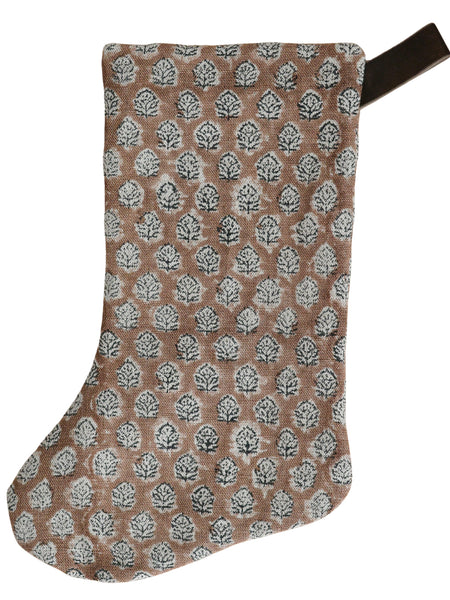 Brick rose block print Christmas stocking featuring a repeating hand-stamped floral motif in white and charcoal with a dark velvet hanging loop.