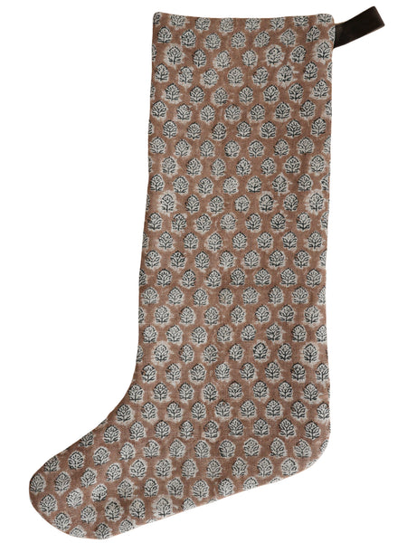Large boho-style Christmas stocking with a brown and white block-printed leaf pattern and a dark velvet hanging loop.