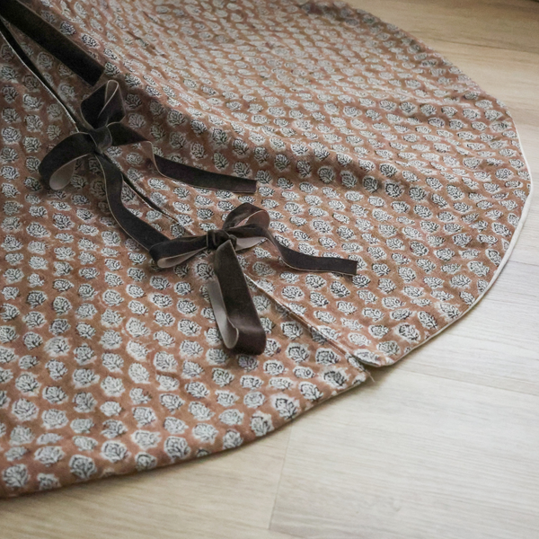 Brick rose block print tree skirt by Hackner Home – handcrafted fabric with velvet ribbon ties in a floral motif.