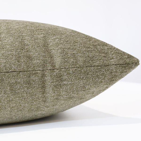Side view of a patina green velvet pillow cover highlighting its smooth, textured fabric and precise seam detail.