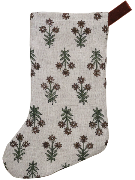 Hackner Home Wood Lily Block Print Christmas Stocking featuring a hand-printed floral design in earthy green and brown tones on a natural linen fabric, accented with a brown velvet hanging loop for a warm, boho-inspired holiday look.
