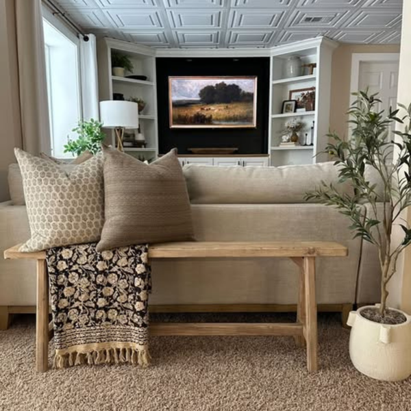The Cocoa brown accent cushion cover styled on a modern white sectional sofa with neutral decor.